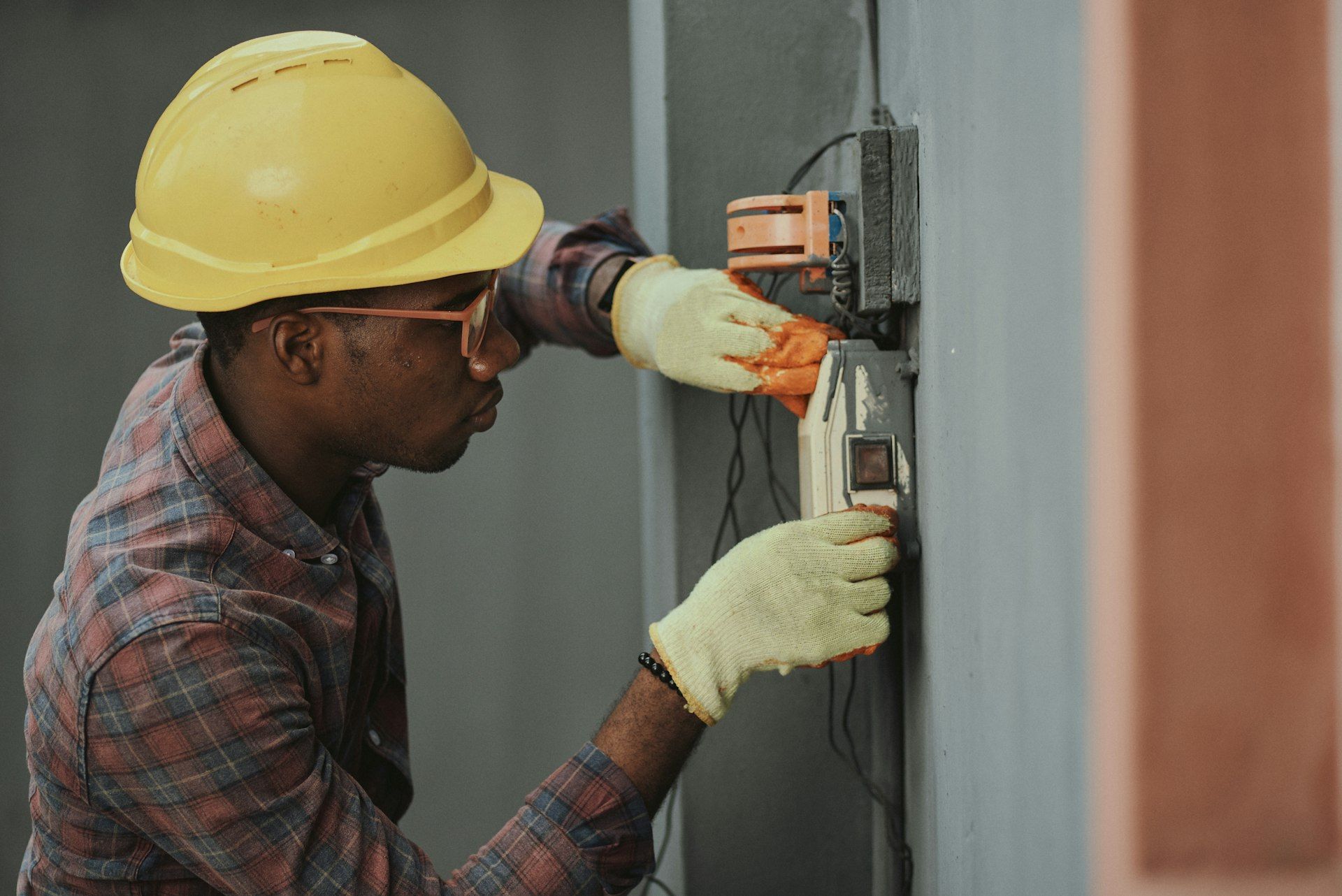 Electrician working on industrial electrical systems